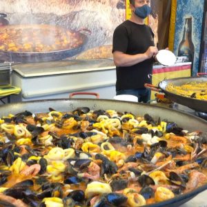 Cooking a BIG Spanish Paella with Seafood. Street food at Italian Food Fair