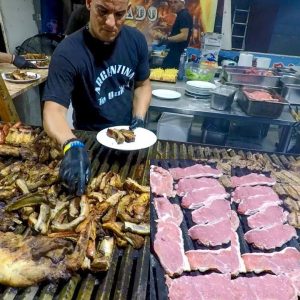 Argentina Street Food. Huge Grills Roasting Ribs, Sausages, Asado and more Meat. Italian Fairs