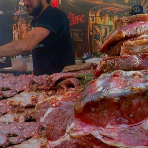 Juicy Pork Loin, Ribs and More Mixed Meat on Huge Grill. Italy Street Food