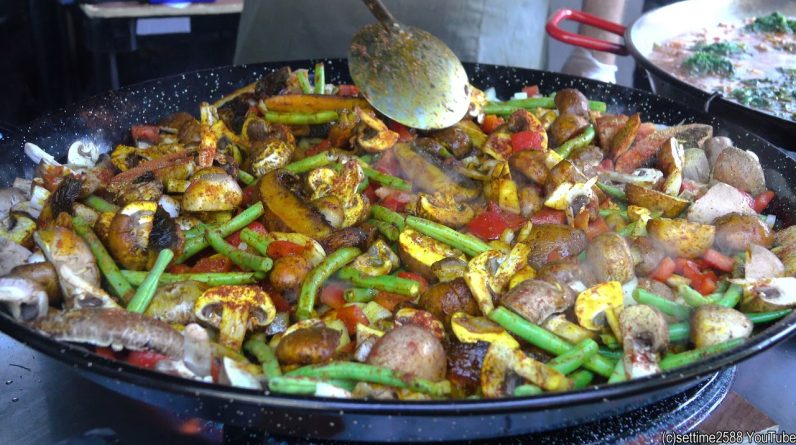 Cooking Spanish Paella with Vegetables and Mushrooms. London Street Food