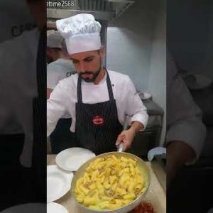 Cooking a big pan of Italian maccheroni Pasta. Food of Turin, Torino, Italy