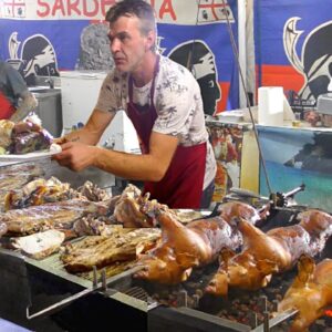 Italy Street Food. Roasting Piglets, Pork Ribs & Lots of Mixed Meat on Grill